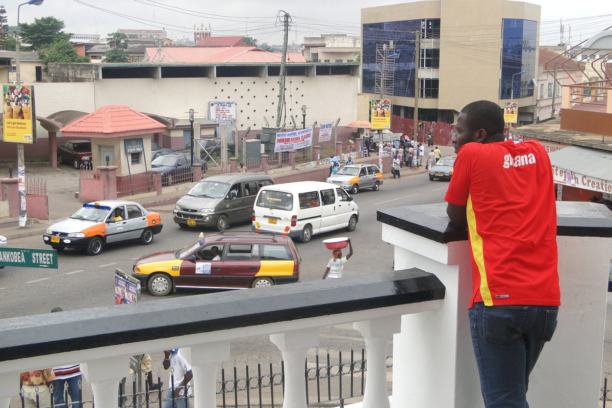 Man Watches Street Scene from Balcony of Barclay's Bank - Kumasi - Ghana, Kumasi, Ghana, 2010