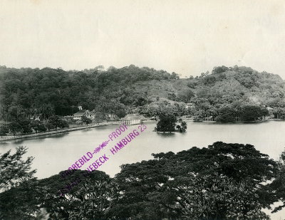 EU: Colombo, Sri Lanka. View over a sea park landscape with lush vegetation and bay with probably artificially designed islets against populated riverside zone (1913), Colombo, 1913