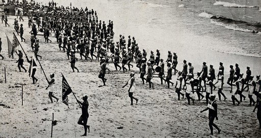 Bondi Beach in 1920 — EU: Bondi Beach, Sydney, Australia: members of Life Saving Clubs put on a display at a surf carnival. Photograph, ca. (1920)