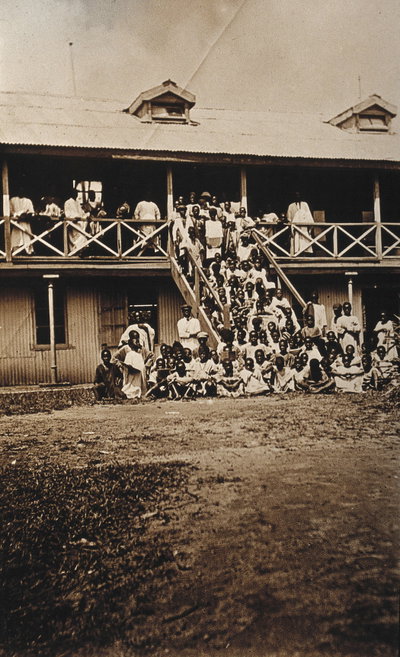 EU: Accra, Ghana: African people waiting to be inoculated on the porch and steps of a (hospital ?) building. Photograph, 1910/1920. (1915), Accra, 1915