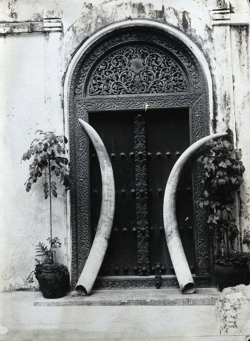 EU: An ornate carved doorway in Zanzibar with elephant tusks (c.1900), Stone Town, Zanzibar, Tanzania, 1900