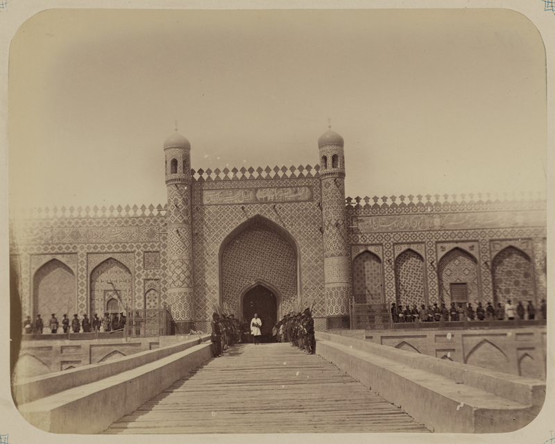 Camel caravan with cotton in 1868 — Kokand Khanate. City of Kokand. Palace of Said Khudoyar Khan, with Soldiers of the Kokand Khan's Army Standing Outside the Entrance, and a Russian Officer Standing in the Center