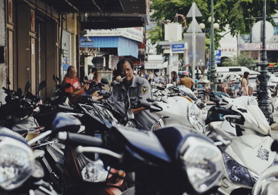 Man smoking with scooters (Unsplash), Ho Chi Minh City, 2017